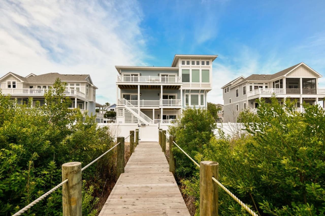 Dock walkway leading back through the shrubs to the home & neighboring cottages.