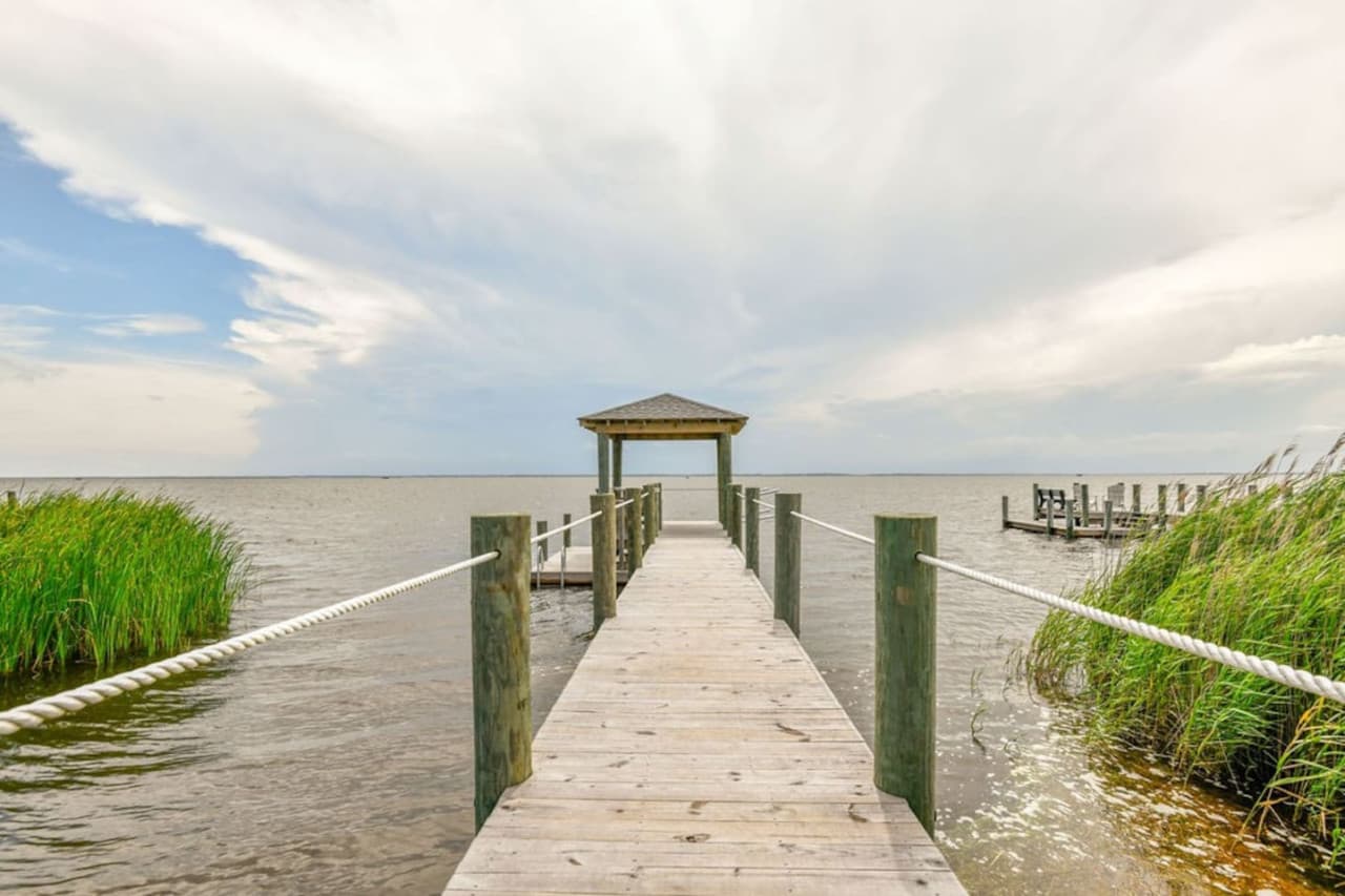 Private dock running out through the marsh grass to a covered platform on the sound.