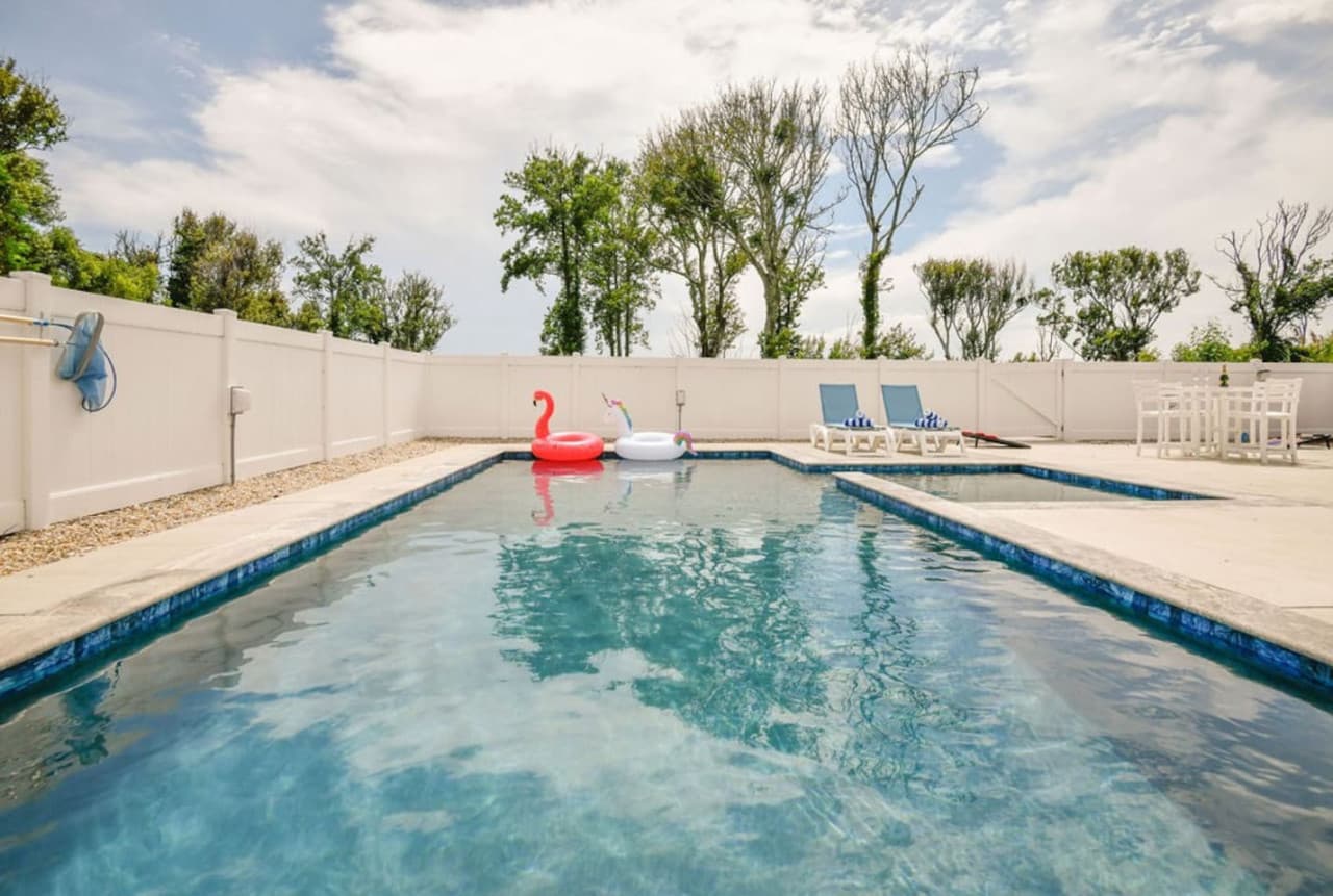 Long, sparkling lap-style pool inviting you to swim, float, or cool off.
