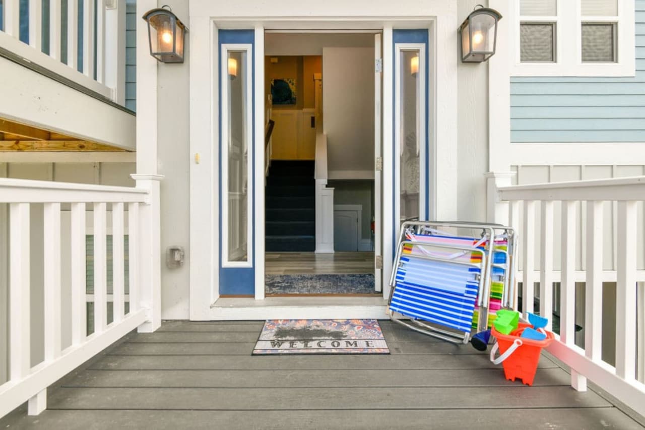 Welcoming entry porch w/ beach gear handy, setting the tone for laid-back stays.
