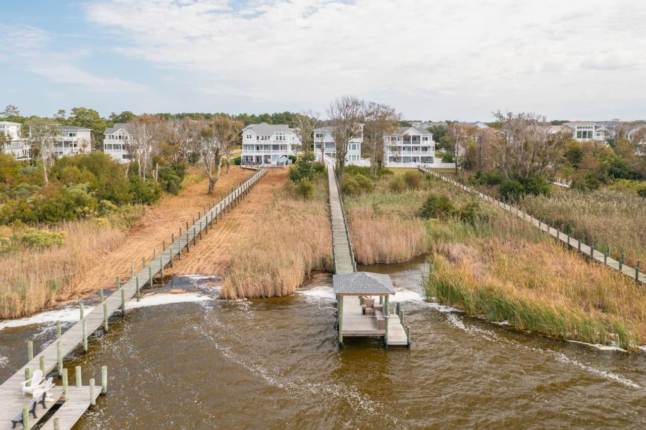 Boardwalk-style path stretching over marshland, offering a peaceful walk through nature.