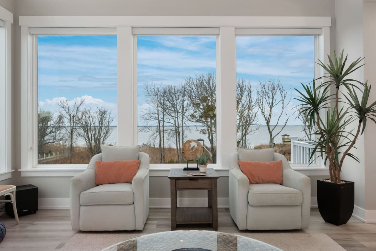 Cozy sitting nook w/ large windows, perfect for morning coffee or quiet moments.