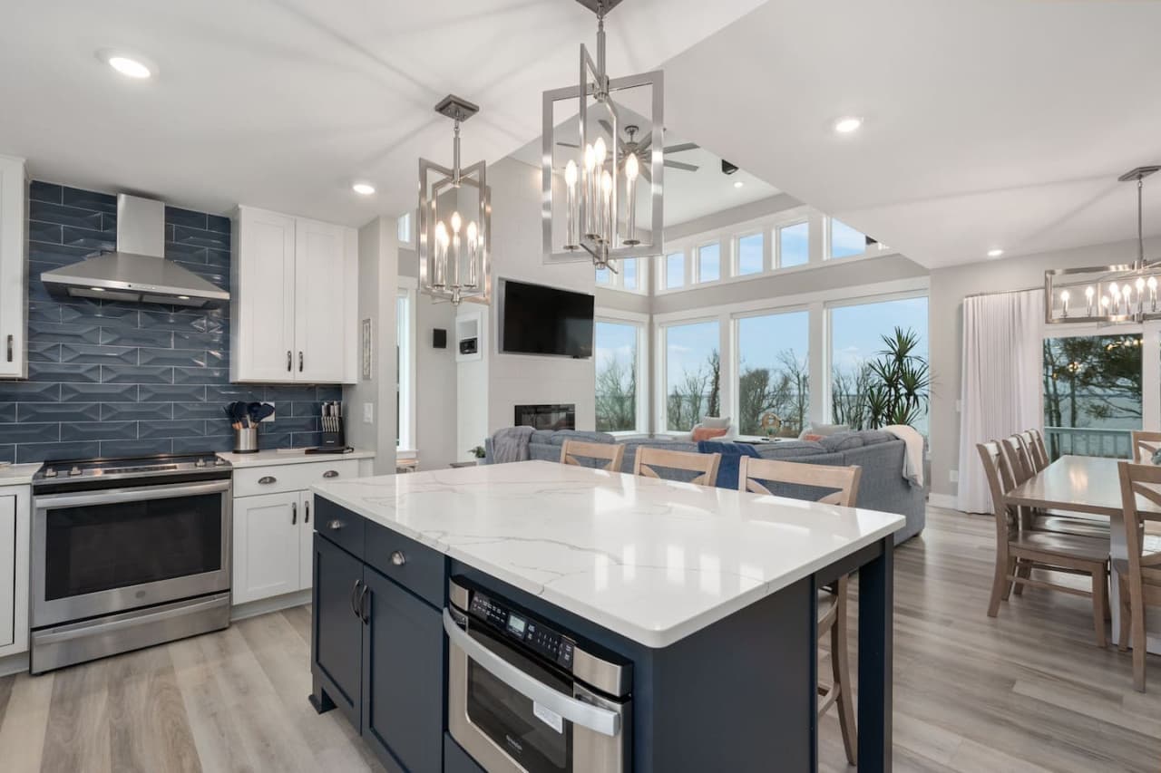 Bright, open kitchen w/ large island, sleek finishes & room to gather.
