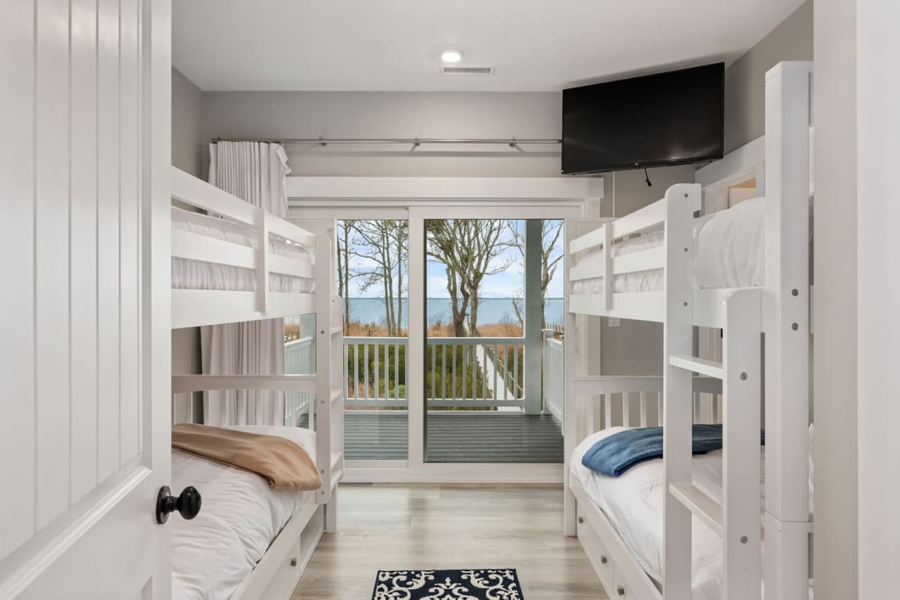 Bunk room w/ two bunk sets, mounted TV & a slider out to the deck w/ sound views.