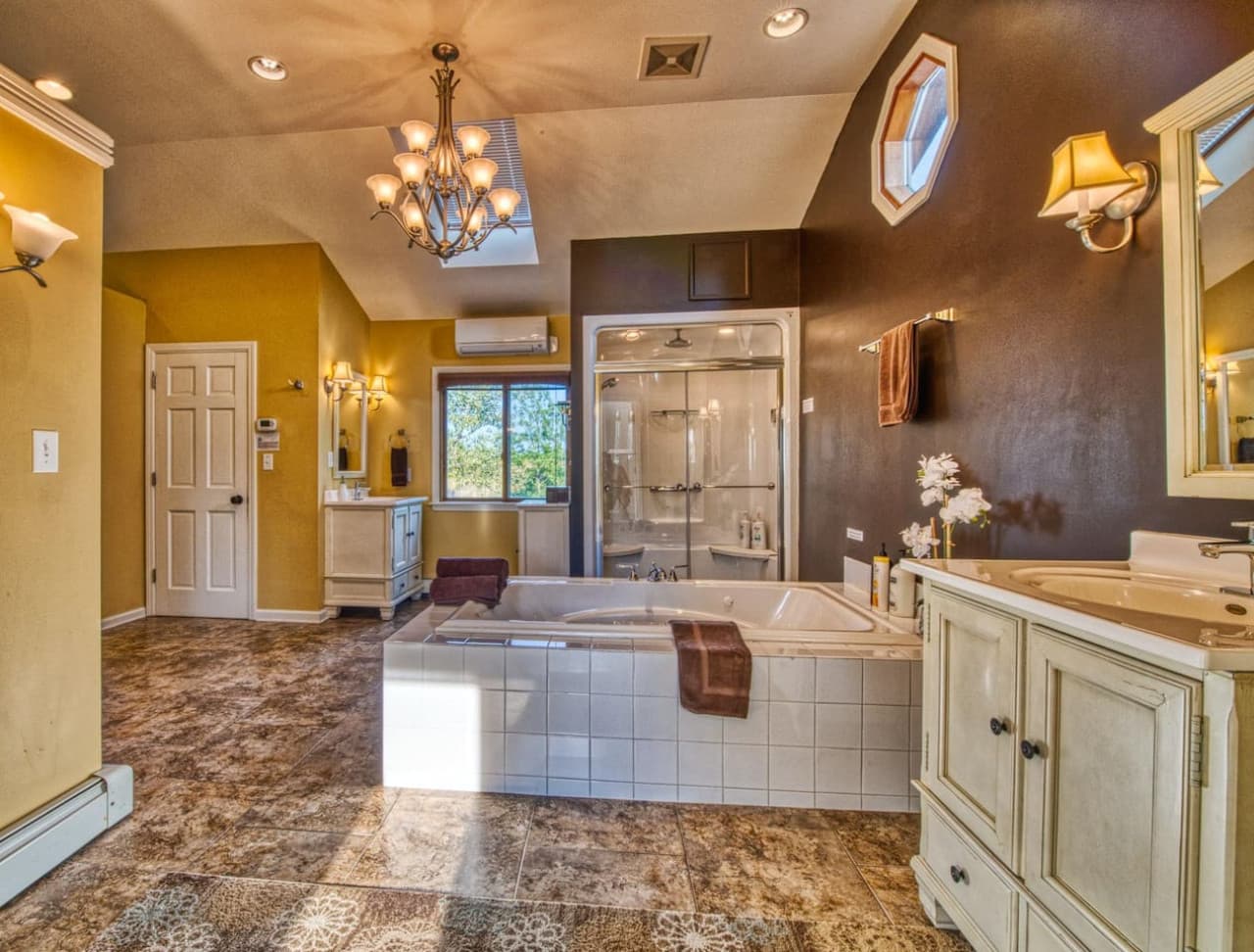 Master Suite Spa Sanctuary features a dry-cedar sauna, steam shower, rainfall shower head, large jetted tub, double vanities, private toilet room, and large walk-in closet