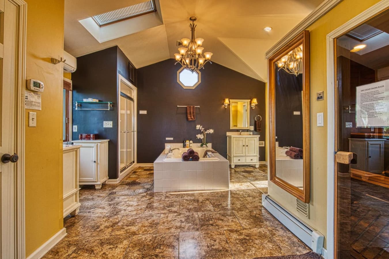 Master Suite Spa Sanctuary features a dry-cedar sauna, steam shower, rainfall shower head, large jetted tub, double vanities, private toilet room, and large walk-in closet
