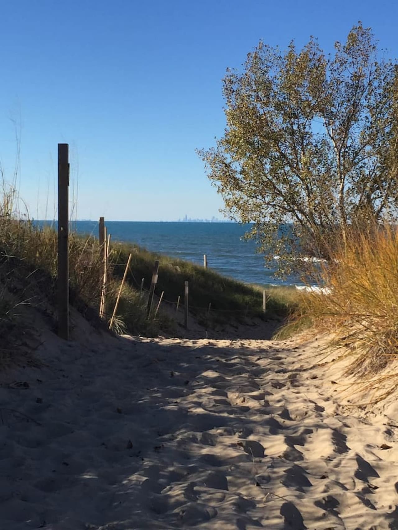 The walk to the beach is approximately 1/6 of a mile and takes the average person about 10-12 minutes along a mostly sand, partially paved path that winds past Historic Chanute Hill, the location of the first manned glider flight in 1896.