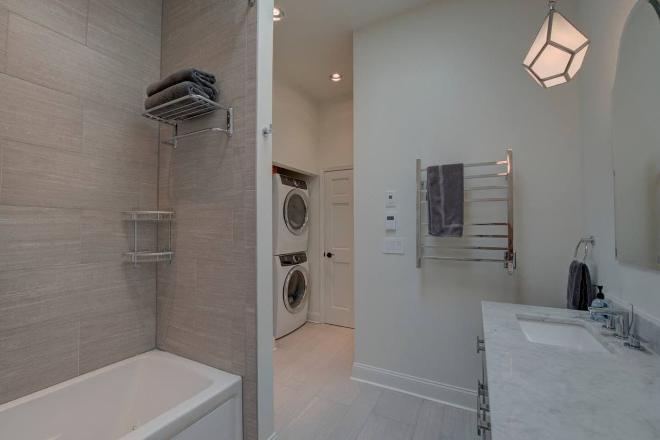 The 2nd floor bathroom features a jetted tub, heated tile floors and towel bars, dual vanity, skylight, full length mirror, and high efficiency Electrolux gas dryer and washer equipped with a PurWash Ozonator.