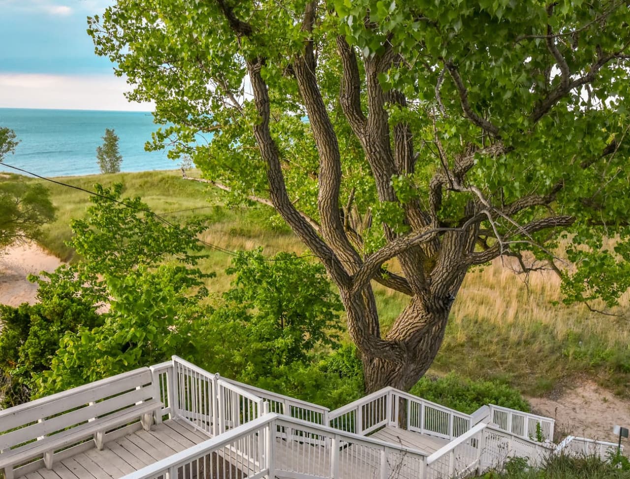 The beach, Lake Michigan, and IN Dunes Nat'l Park are accessed via a sand path at the base of private stairs leading from the Villa Santorini terrace