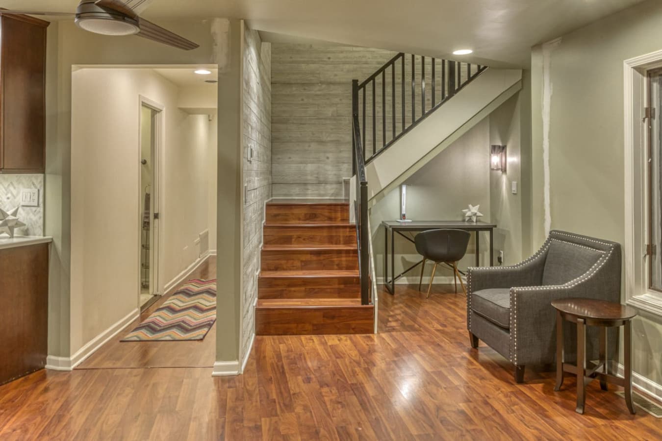 Second Floor Media Room features a desk, lamp, and chair in a quiet nook under the stairs leading to Level 3