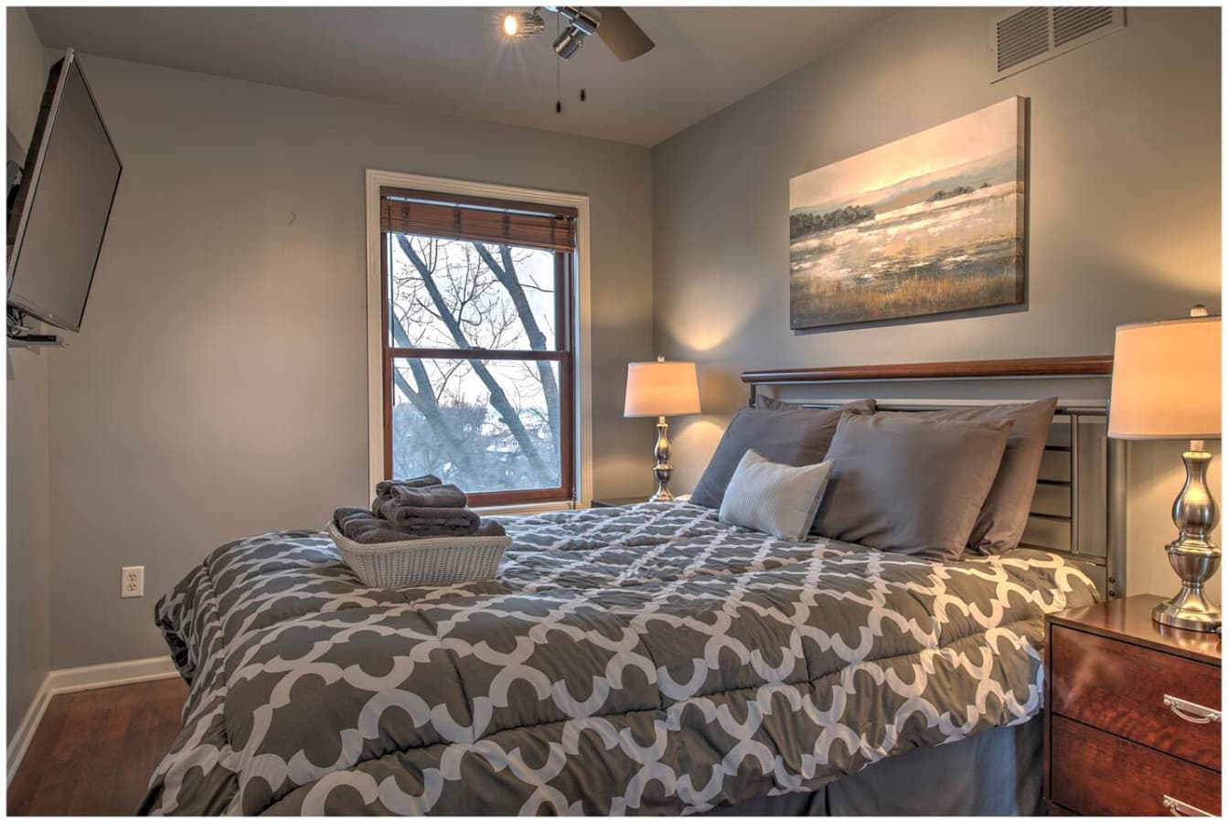 The Sunset Bedroom features a queen bed, Smart TV, and beautiful sunset terrace views.