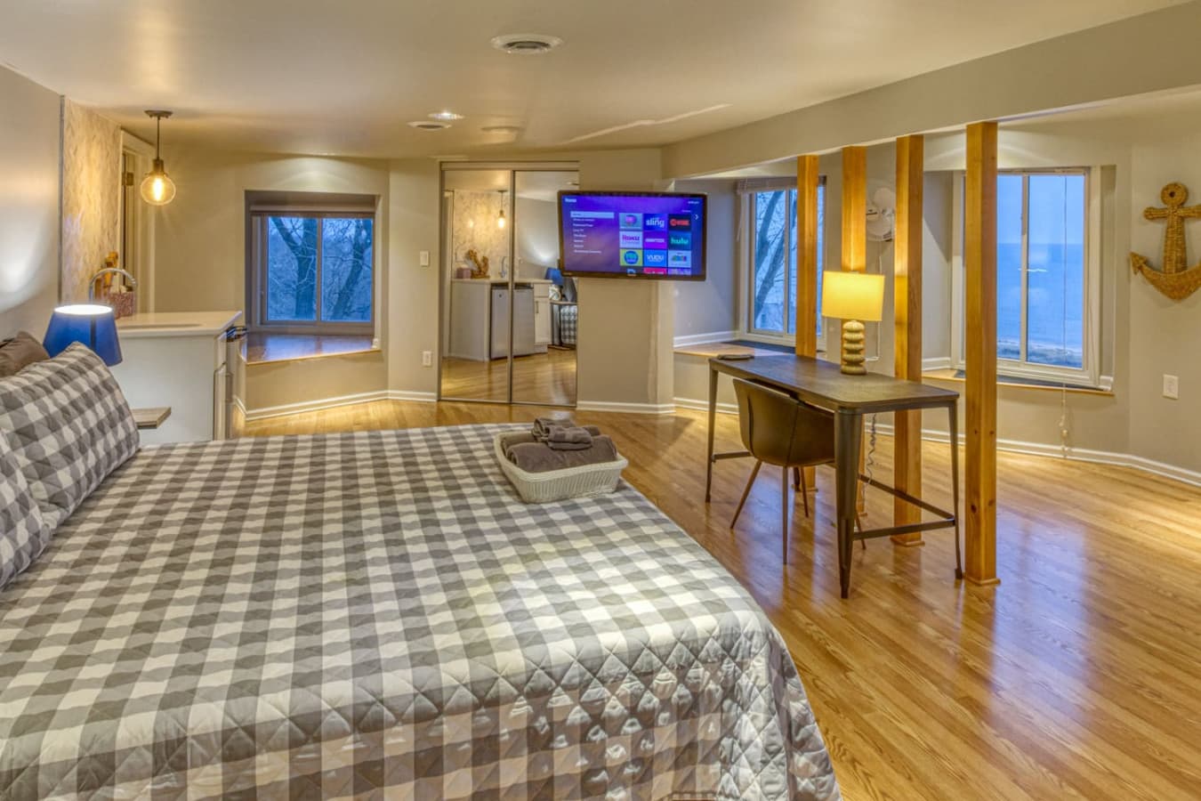 Nautical Suite on Level 3 features stunning views of Lake Michigan, a king bed, dedicated workspace with desk, lamp, and chair, wet bar with wine fridge, and access to full bath (shared with adjacent skylight queen bedroom)