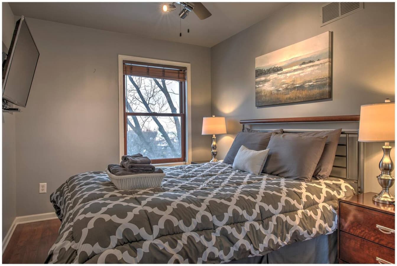 The Sunset Bedroom features a queen bed, Smart TV, and beautiful sunset terrace views.