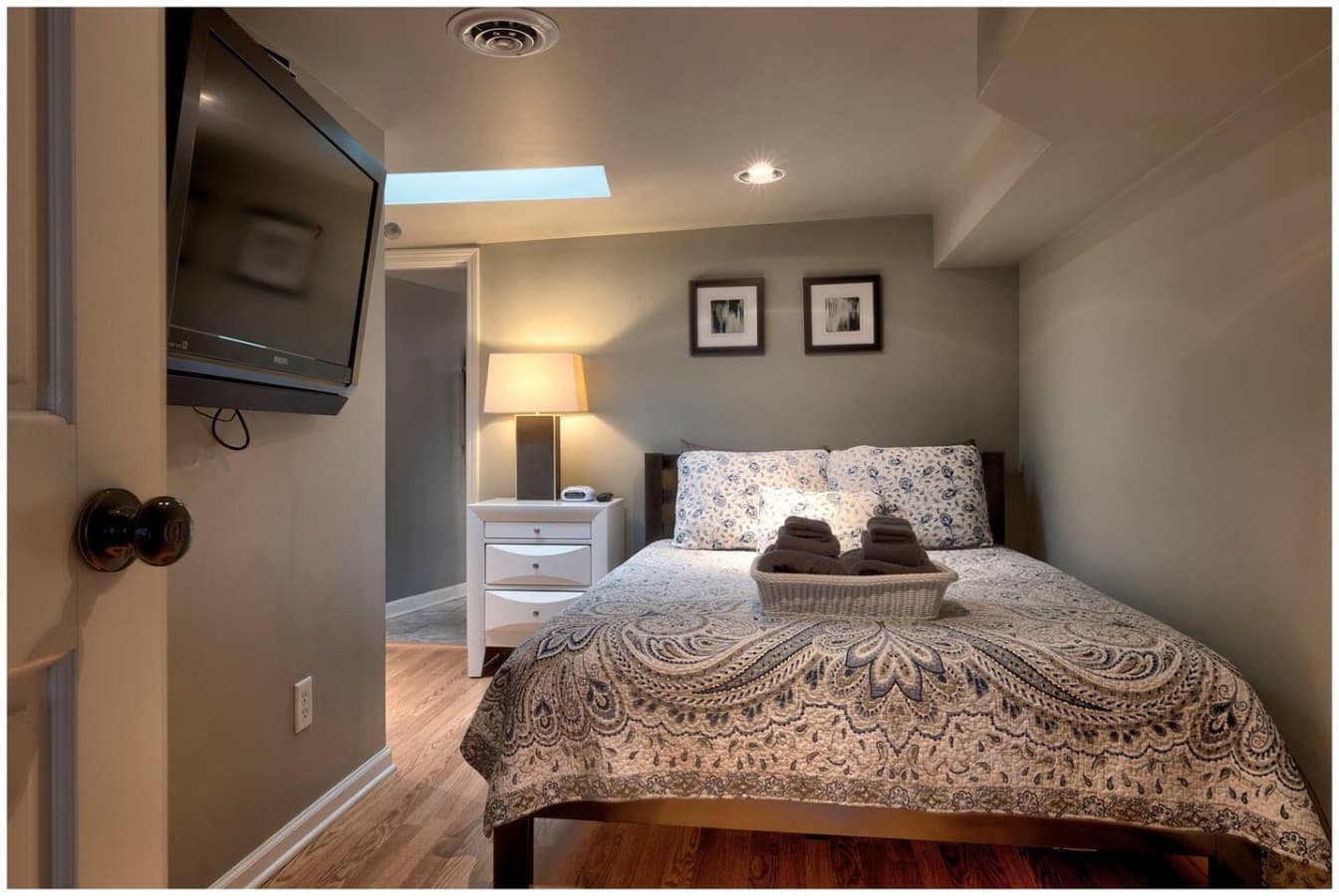 The Skylight Bedroom features a queen bed, Smart TV, and beautiful natural light from the overhead skylight.