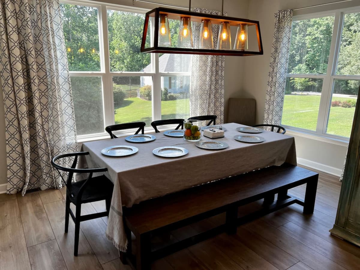 Dining room has tons of natural light and sitting for nine.