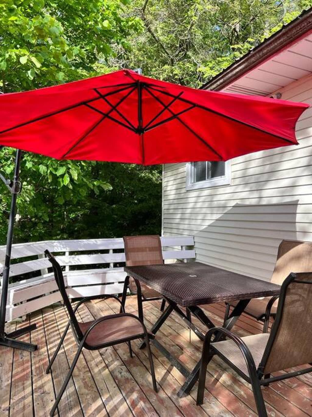 Outdoor deck with dining area and BBQ.