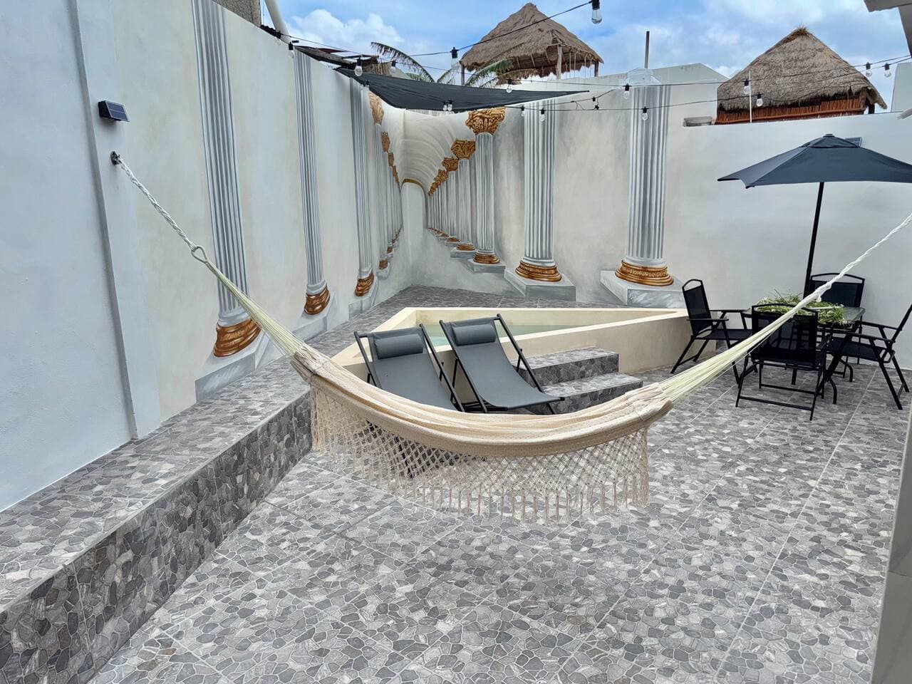 Hammock, Sun Loungers, Dining Table, Custom Patio Tiling.