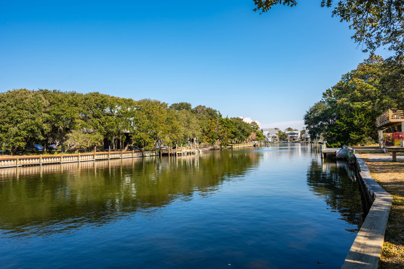 Peaceful canal view lined w/ trees, offering a serene backdrop for your stay.