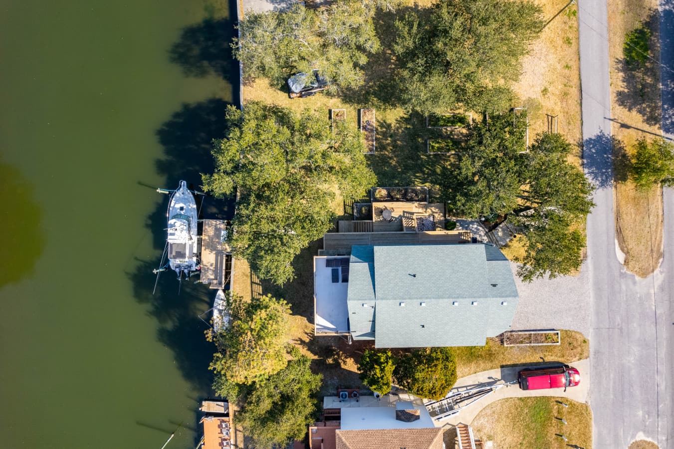 Overhead look at the home near the water, highlighting its setting within the neighborhood.