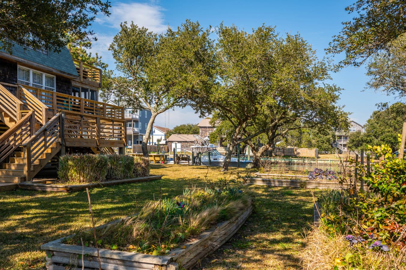 Backyard view w/ trees and outdoor stairs, offering a quiet spot to enjoy the surroundings.