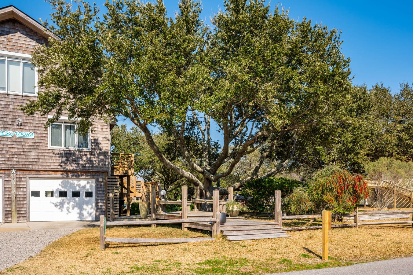 Quiet path lined w/ greenery and fencing, offering a calm stroll through the neighborhood.