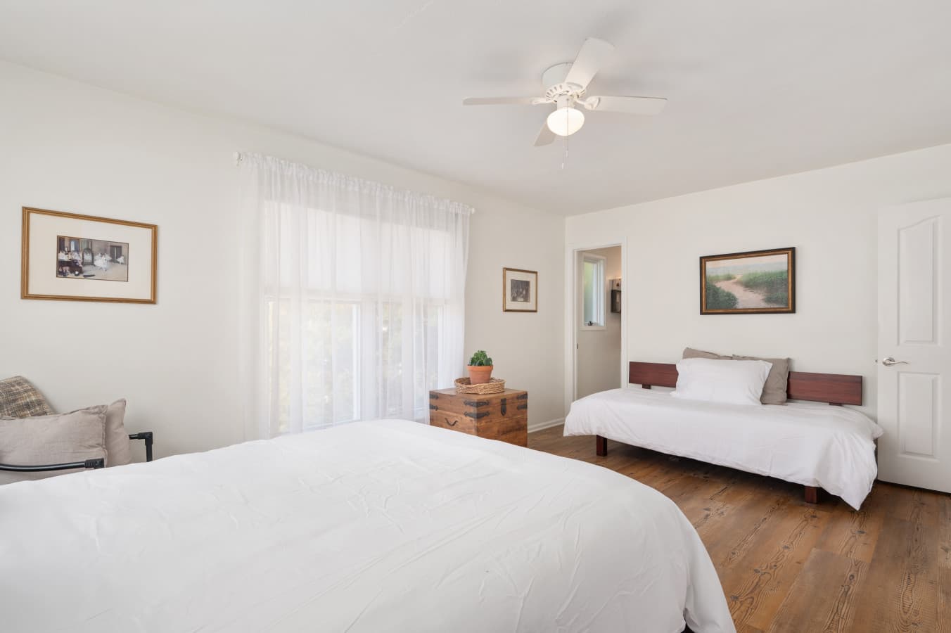 Bright bedroom w/ soft linens, natural light, and simple decor for restful nights.