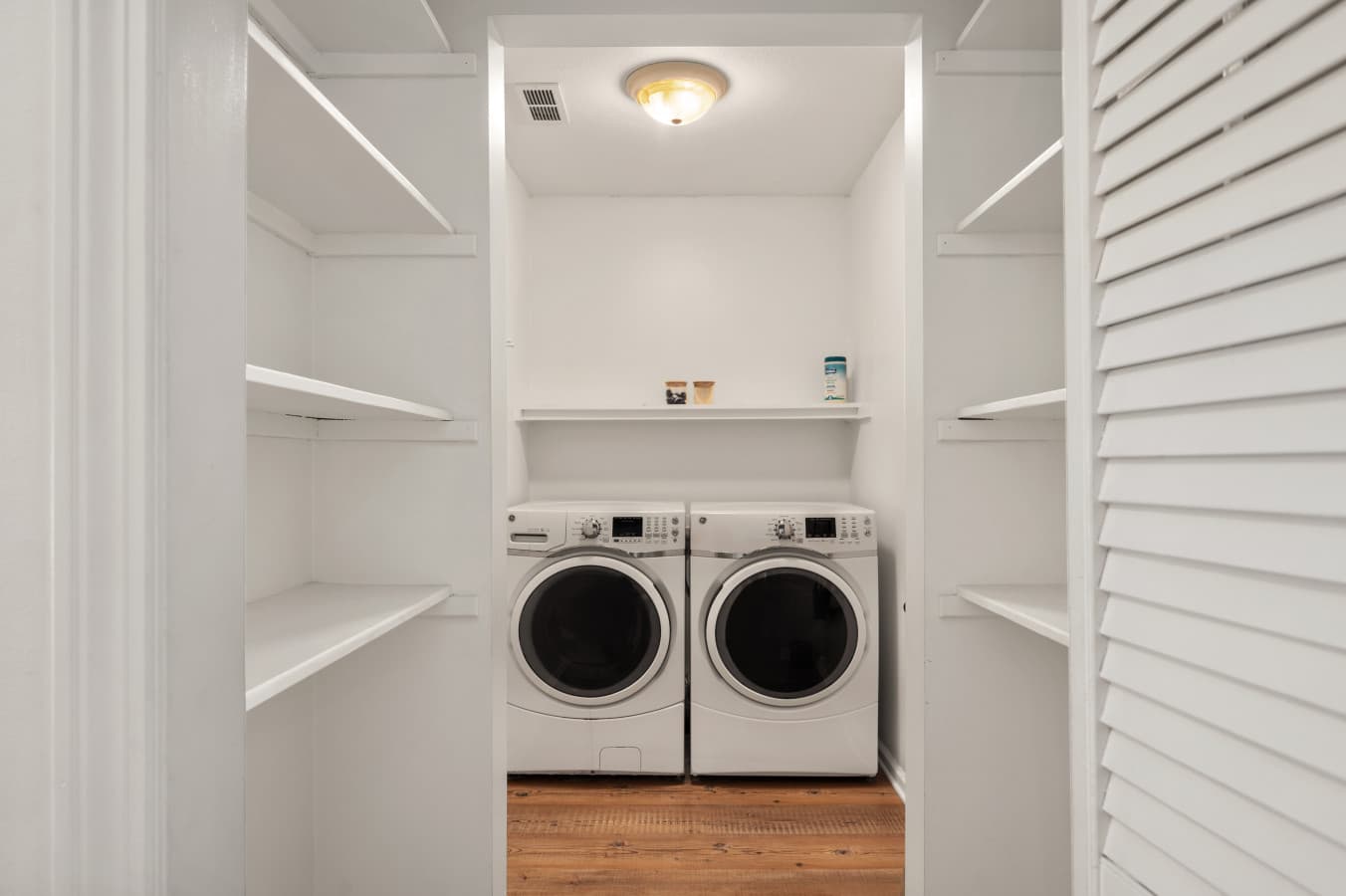 Dedicated laundry area w/ washer & dryer neatly tucked into a clean, organized space.