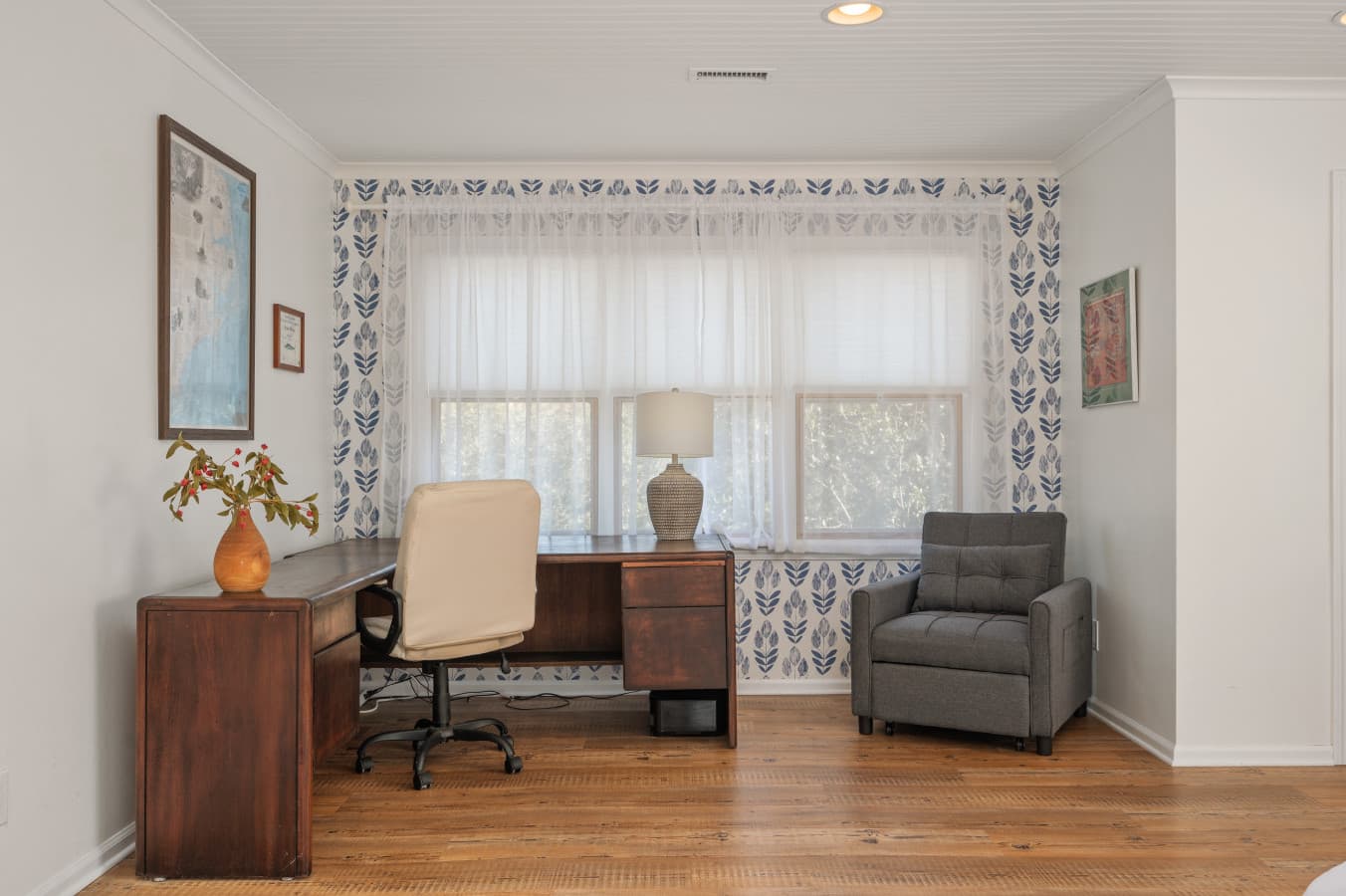 Relaxed sitting area w/ armchairs and natural light, perfect for reading or quiet chats.