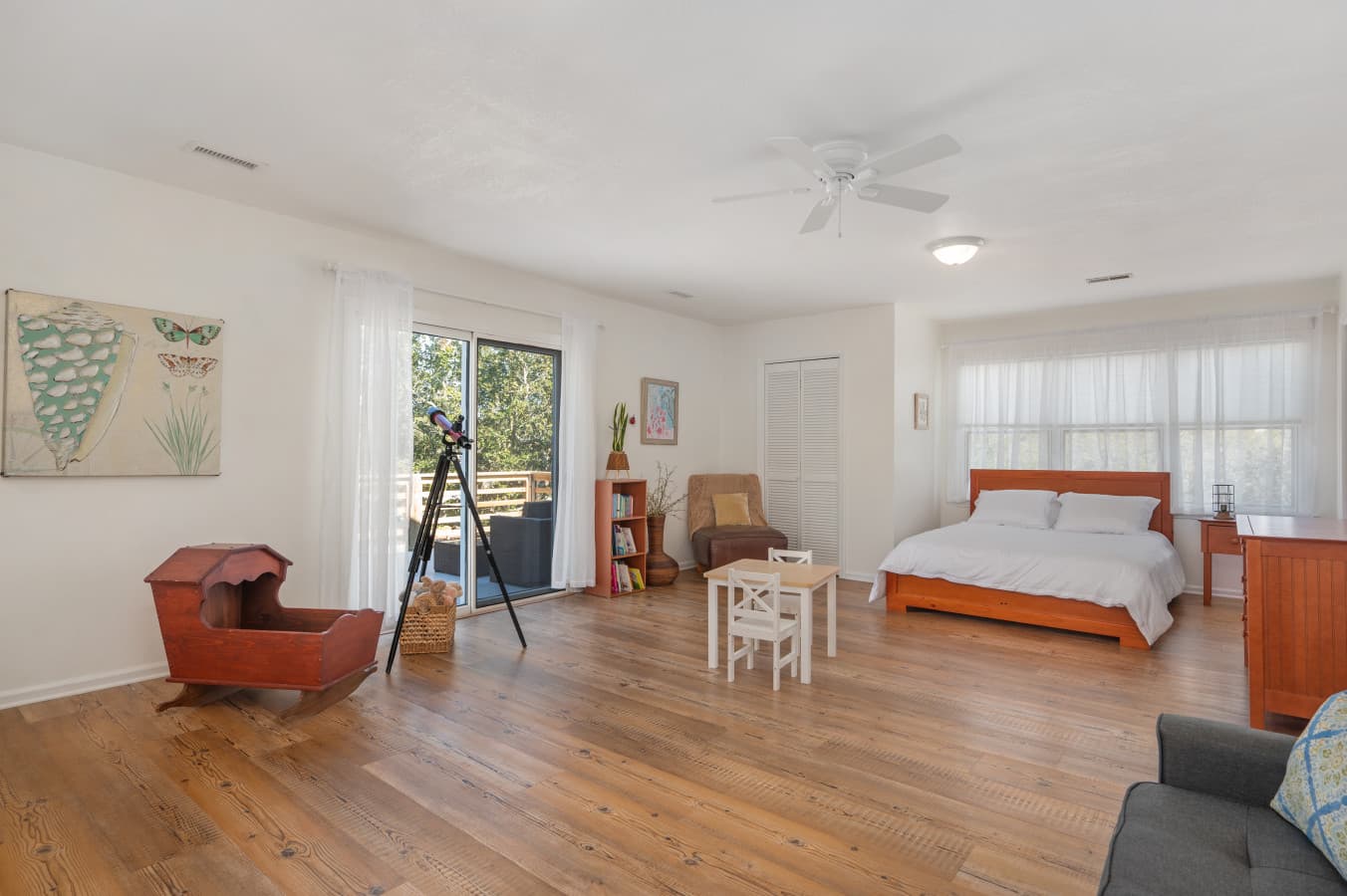 Open living space w/ cozy seating and an adjacent bedroom, designed for easy group flow.