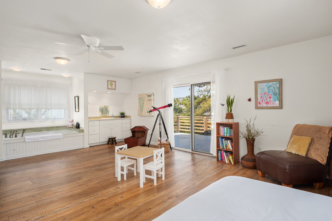 Bright dining area w/ table, chairs, & playful decor, great for shared meals and gameS.