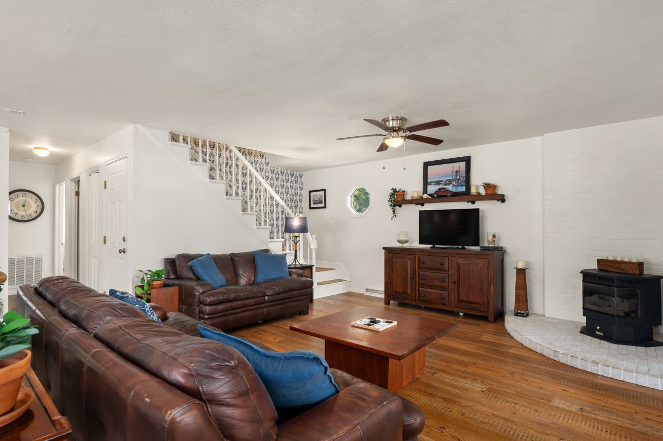 Inviting living room w/ plush seating, ceiling fan, & open layout made for unwinding together.