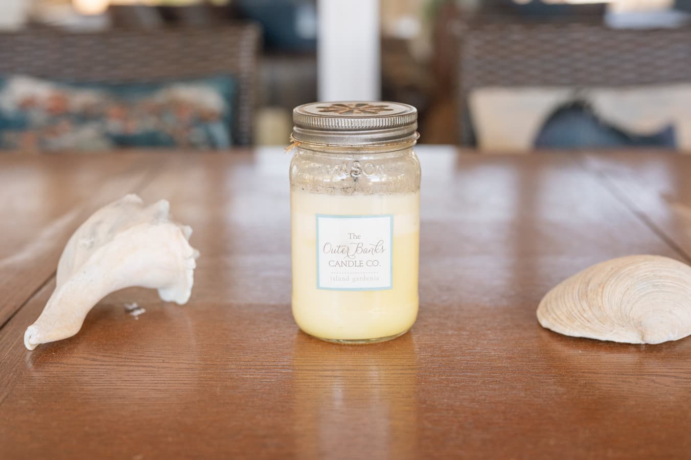 Tabletop detail w/ a jar candle & seashells for a simple coastal touch.