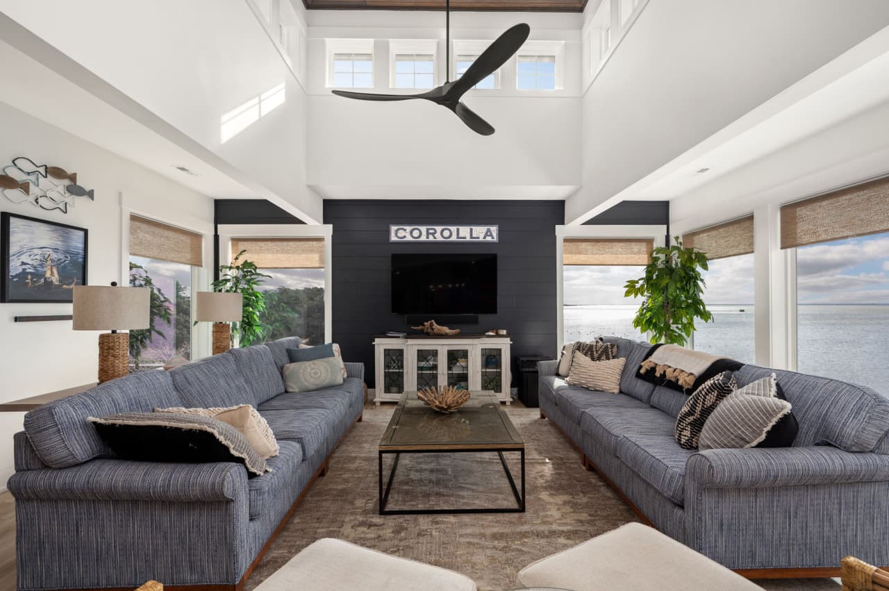 Spacious lounge w/ cozy seating, bold patterns & seamless flow to the dining area.