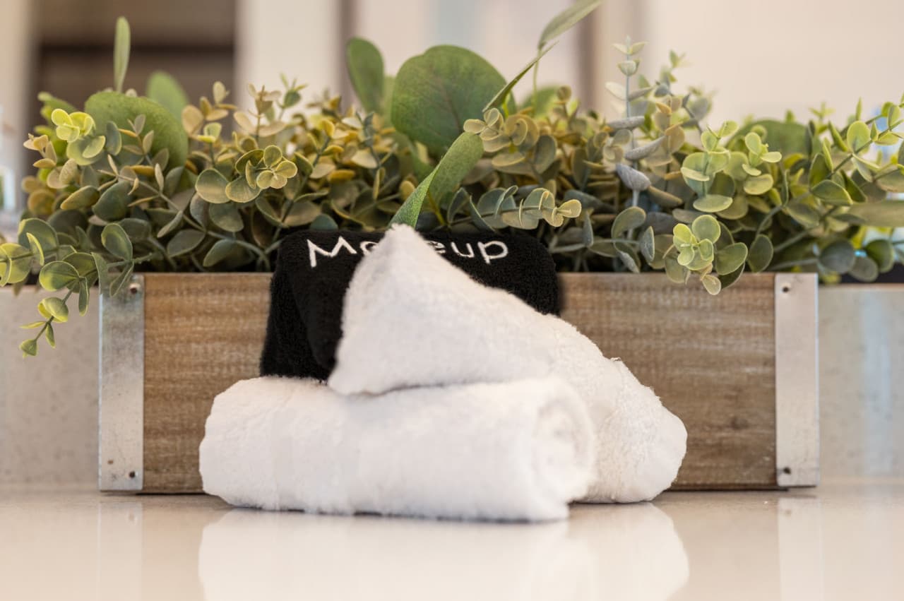 Fresh white towels styled w/ greenery for a spa-like touch from the moment you arrive.