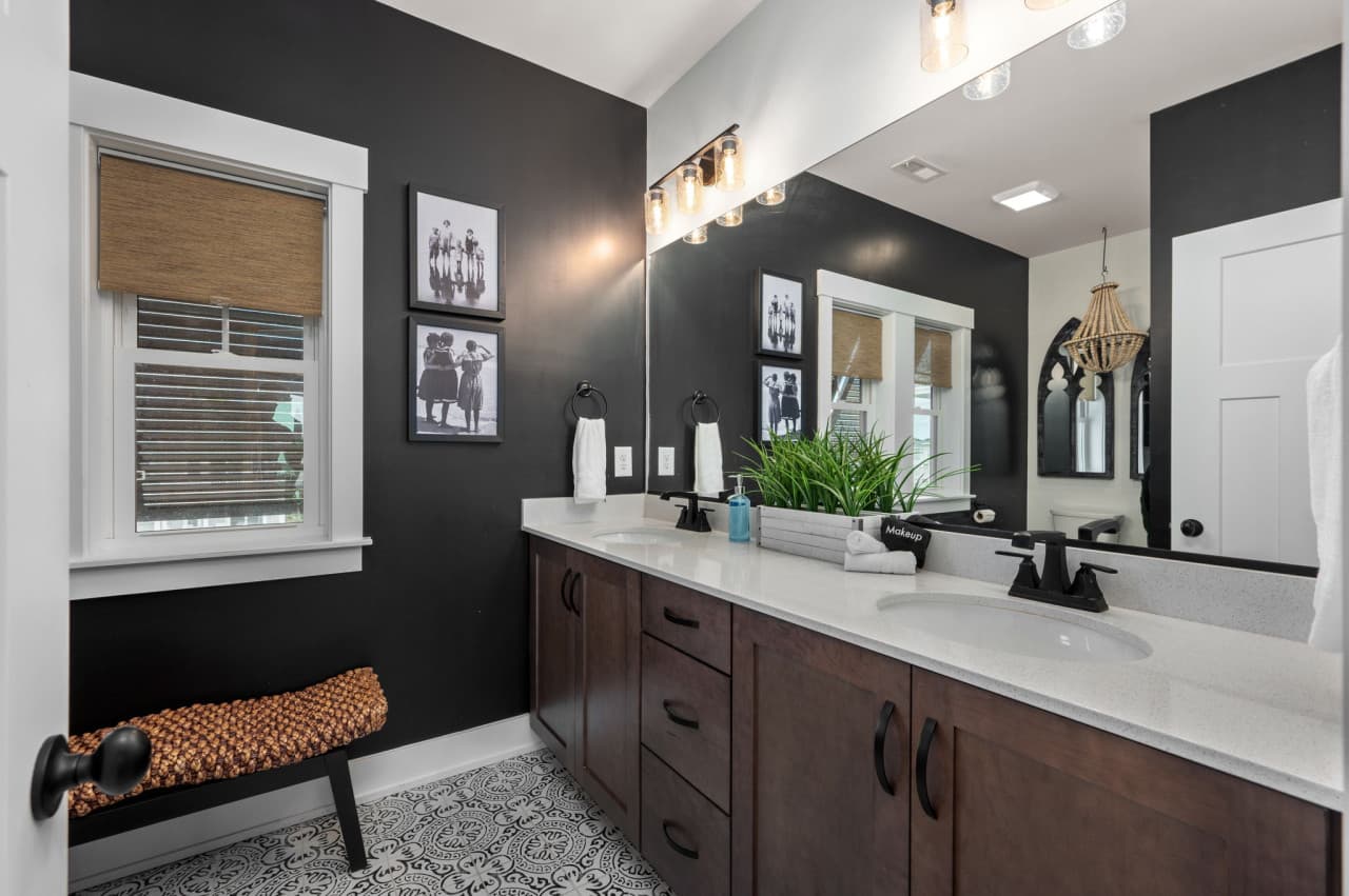 Stylish bathroom vanity w/ dual mirrors, bold contrast & thoughtful lighting.