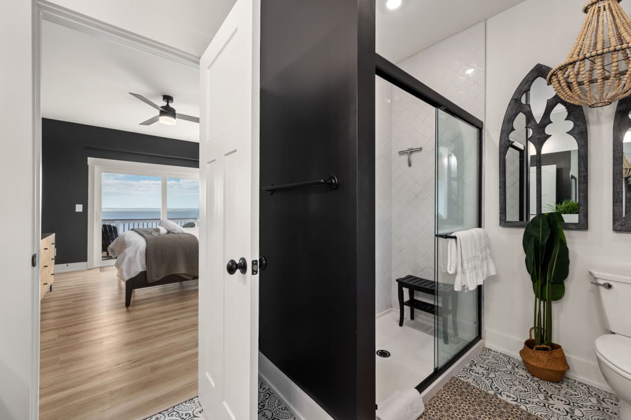Shower-tub combo w/ clean lines, soft light & a fresh coastal feel.