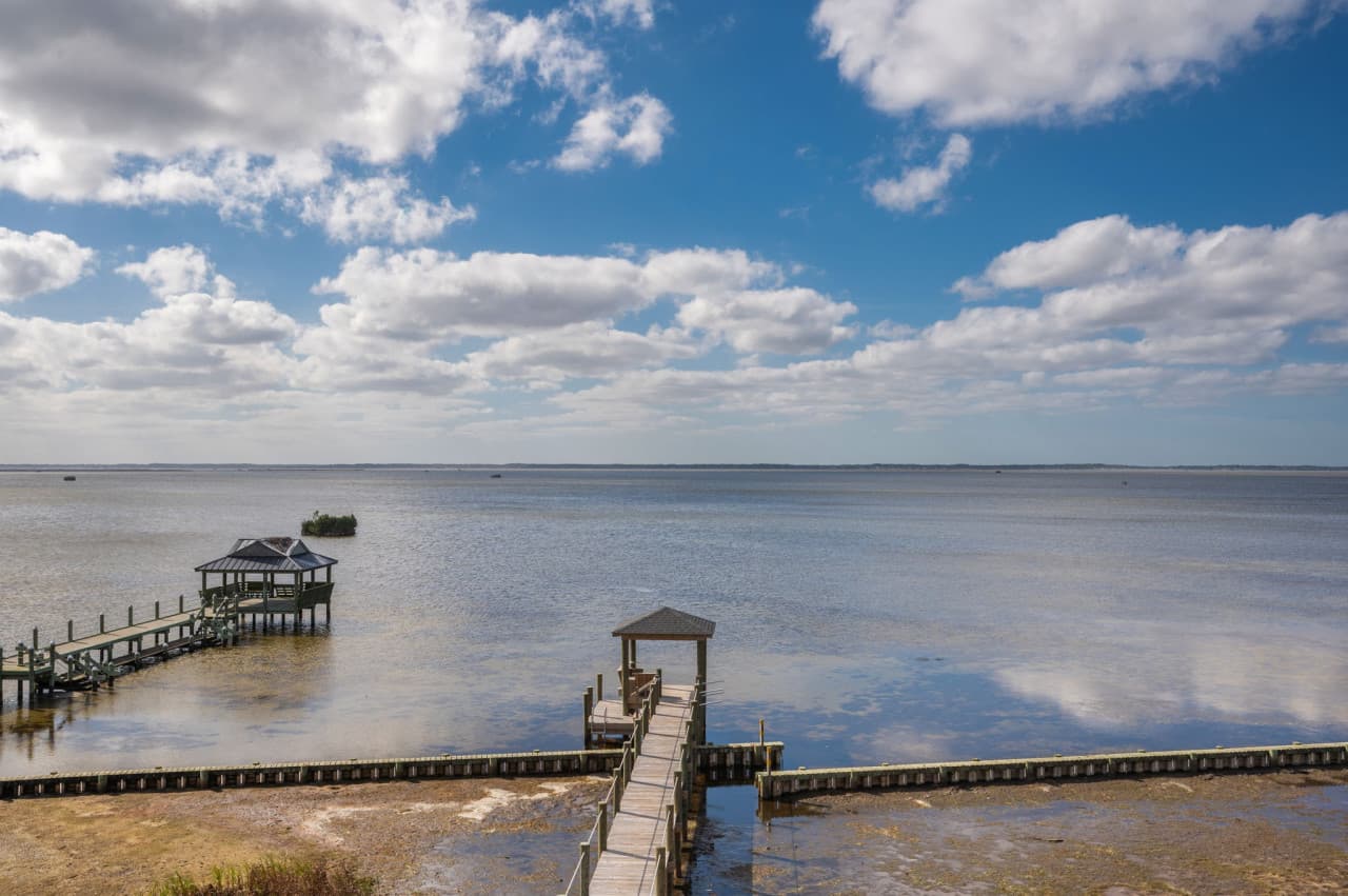 Peaceful waterfront scene w/ wide-open water views & a quiet coastal feel.