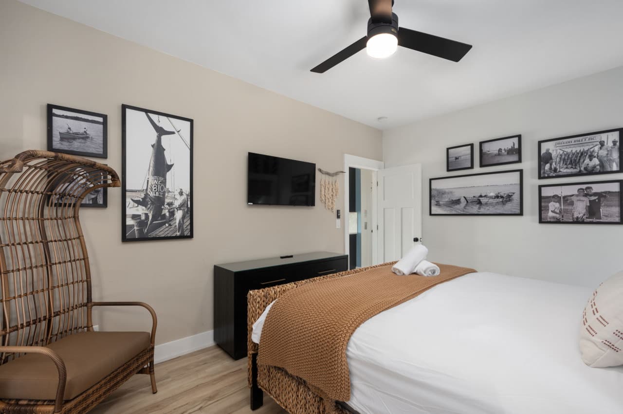 Cozy bedroom w/ layered textures, woven accents & warm lighting for a relaxed retreat.