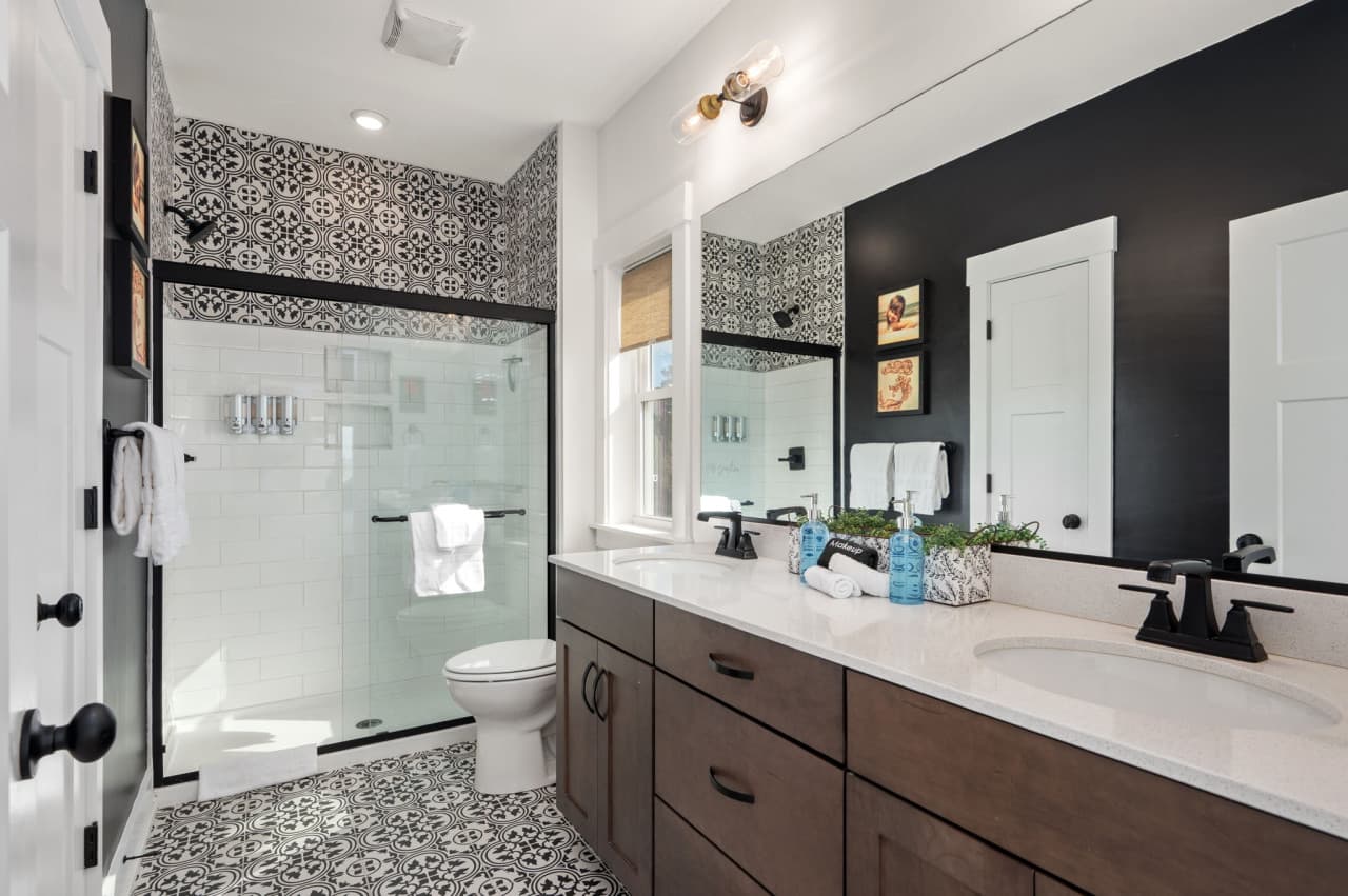 Clean bathroom w/ glass shower, modern fixtures & a fresh, coastal-inspired feel.