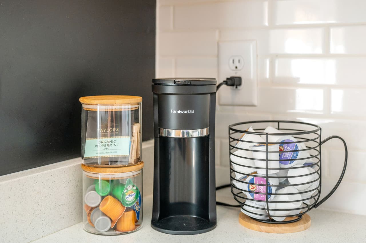 Coffee station detail w/ a single-serve brewer, pod jar & mugs ready each morning.