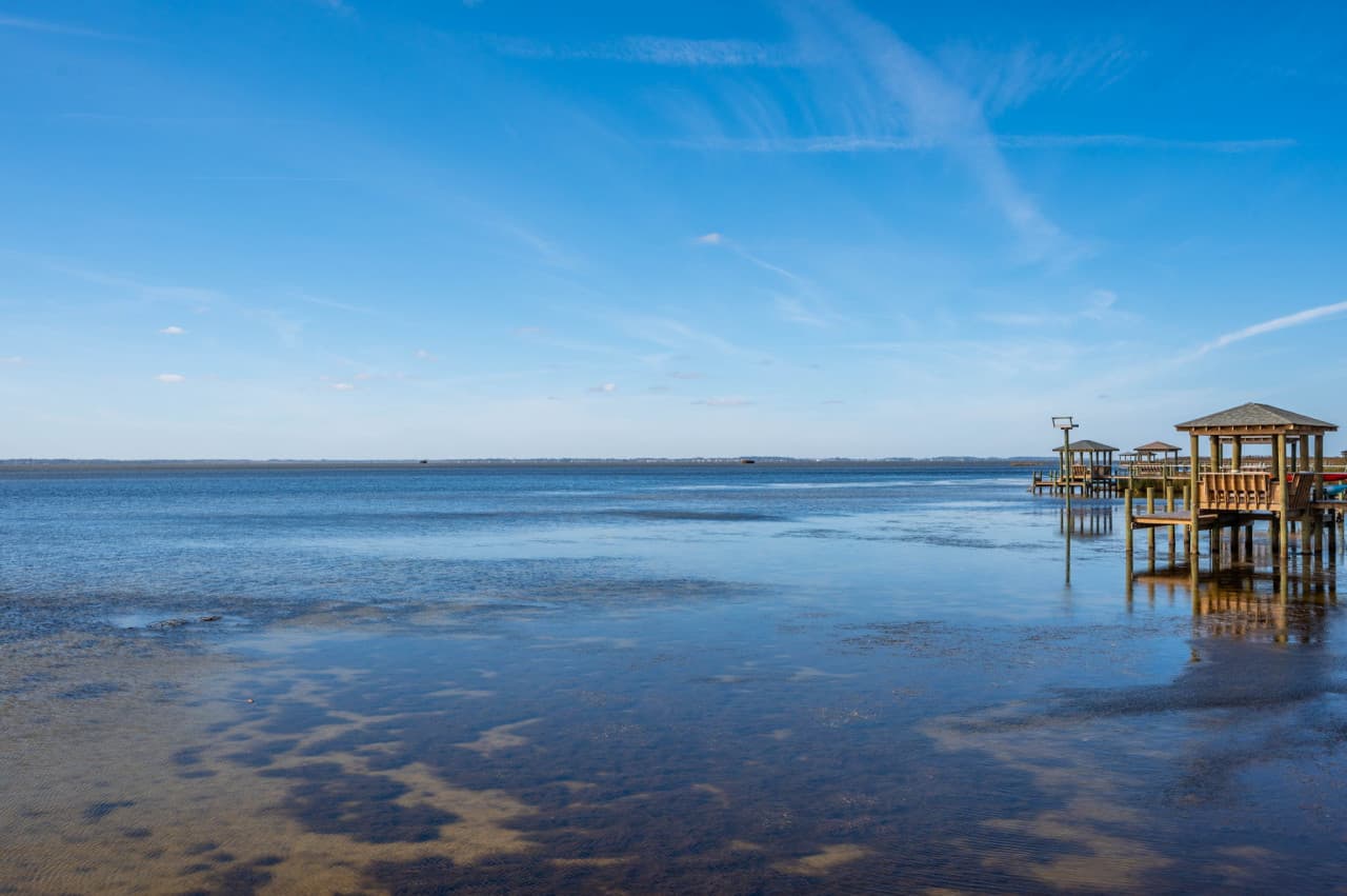 Wide view across the shallow sound w/ the covered pier just off the shoreline.