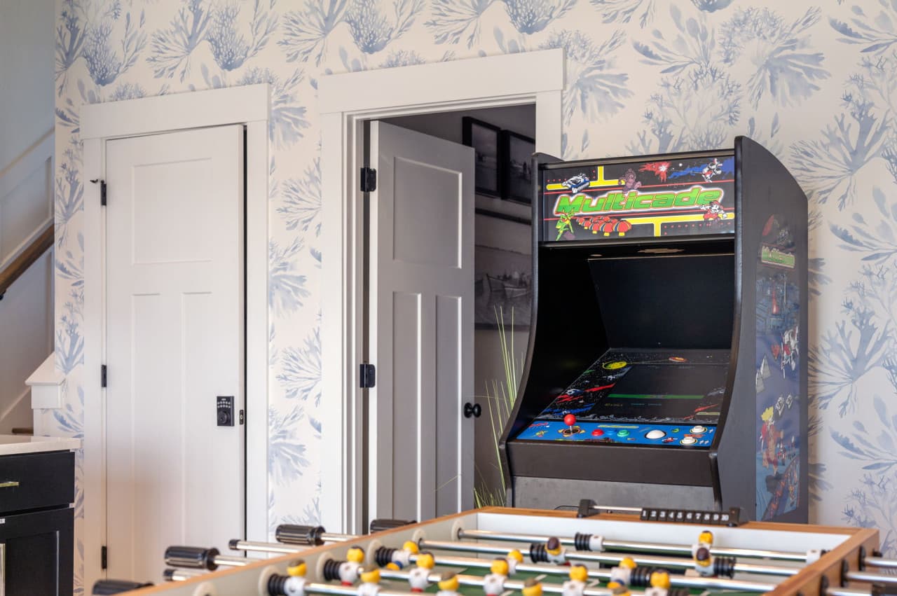 Arcade cabinet & foosball set up by the doorway for easy games any time of day.