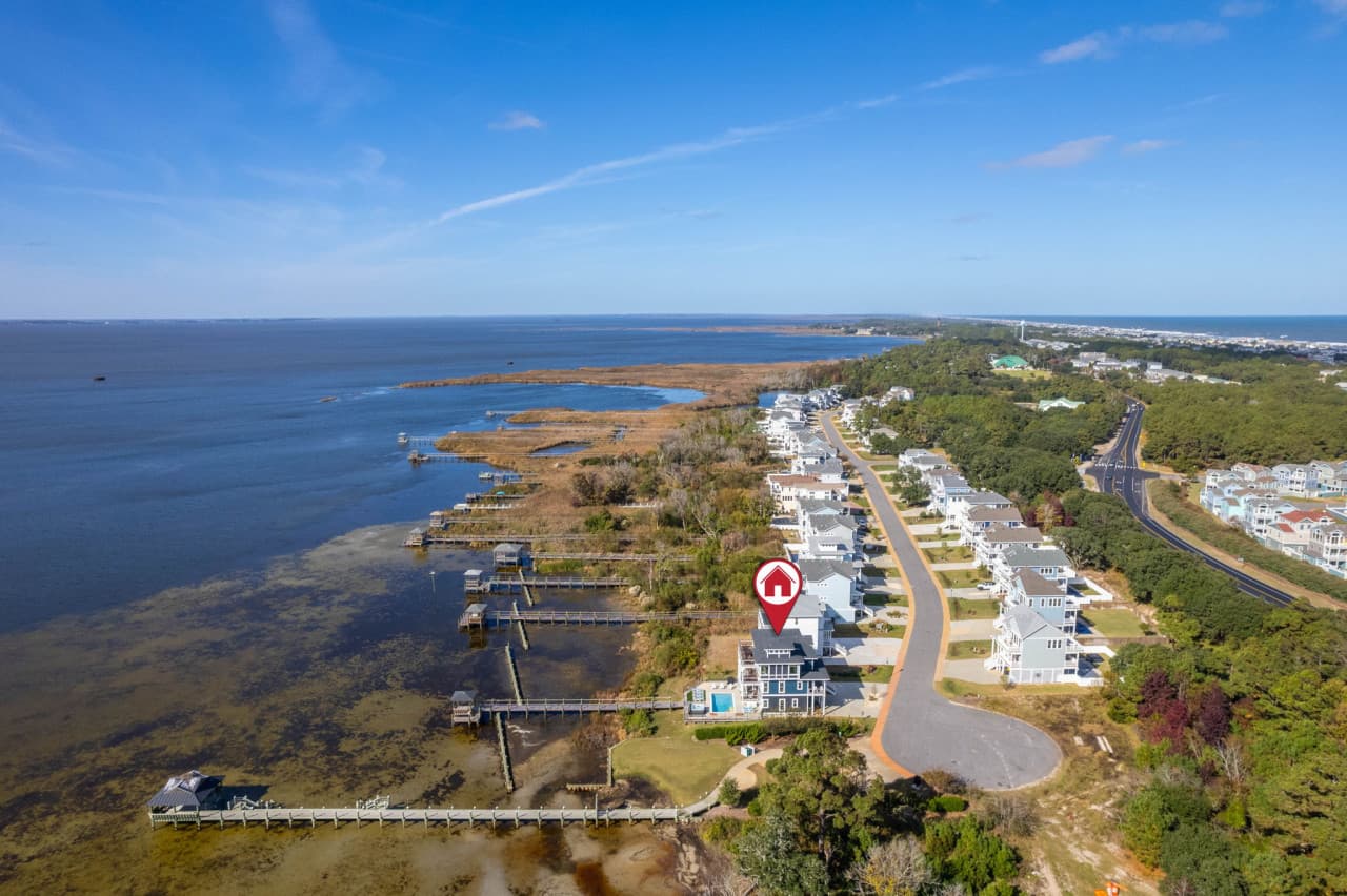 Aerial w/ the home marked among the soundfront row, marsh and water all around.