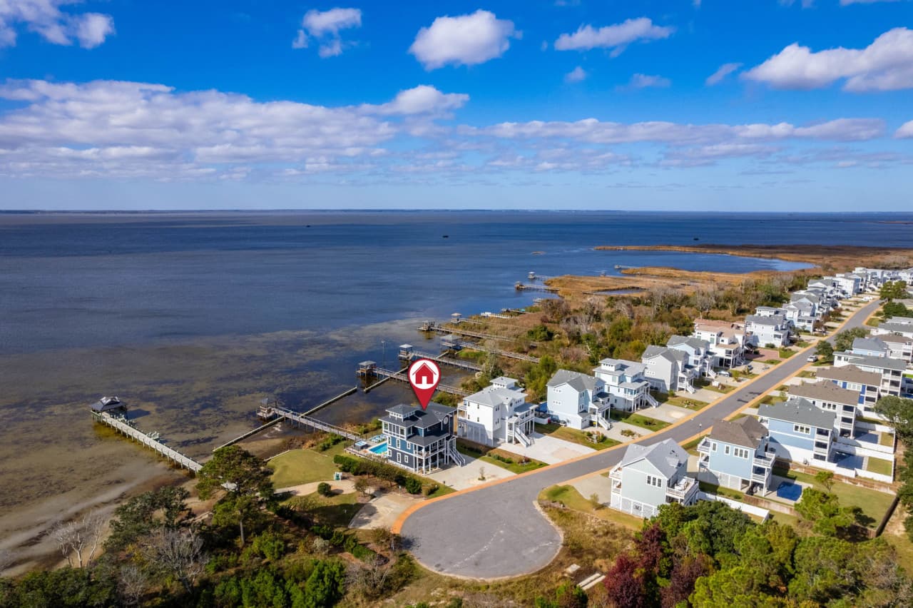 Aerial looking down on the home & its neighbours right at the sound's edge.
