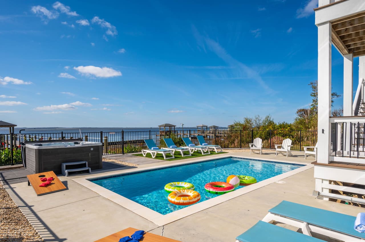 Private pool w/ floats, loungers & a hot tub, all facing out toward the sound.