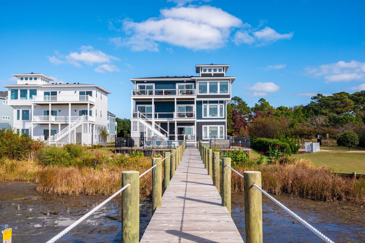The home seen from the pier out front — three levels of decks facing the sound.