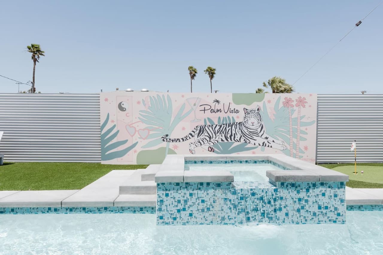 Bask in the sun's glow next to our favorite vibrant tiger mural - your exotic backdrop in Palm Springs!