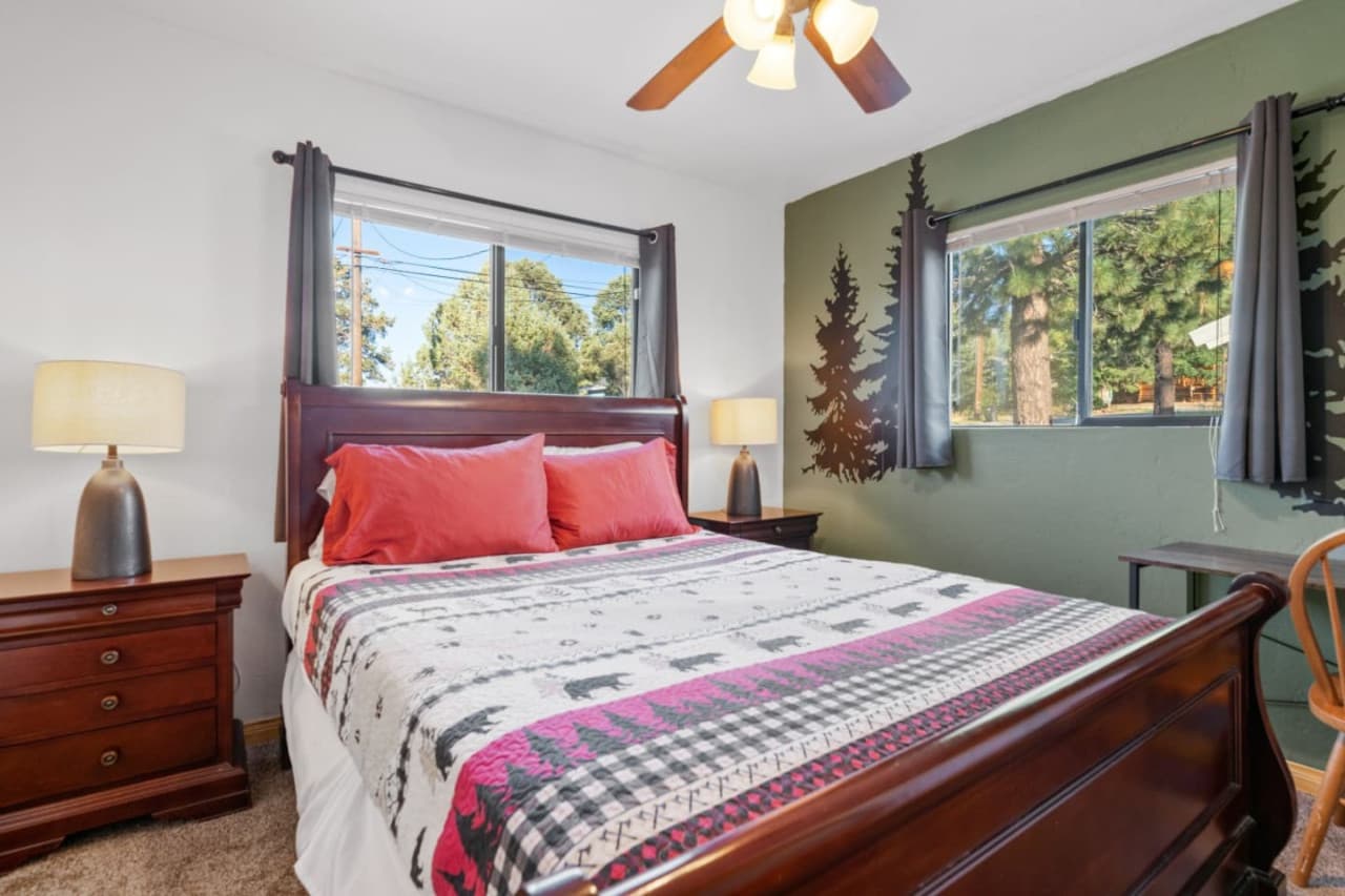Relax in style in our room that features a cozy double bed, refreshing ceiling fan, bedside table, and captivating decor.