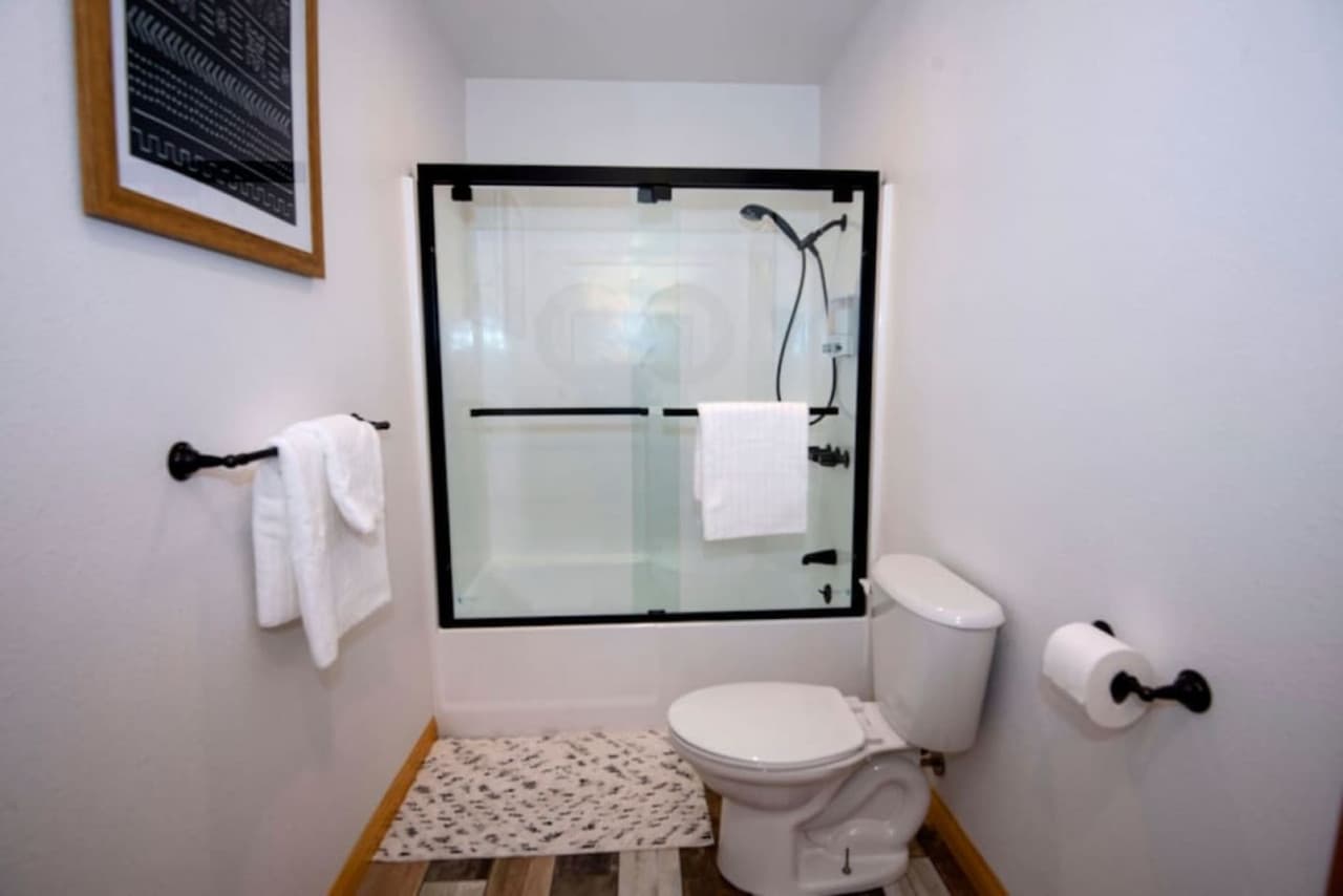 Second bathroom a bath- shower combo, equip with towels, shampoo, conditioner, body wash, hand soap, hair dryers and ample toilet paper -Rather Be Properties