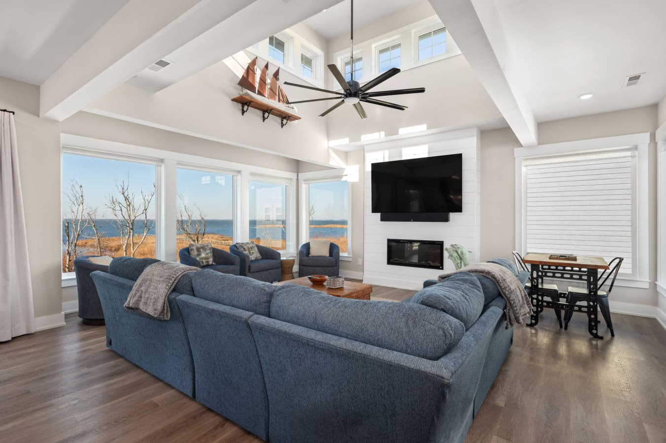 Open-concept living area w/ cozy seating, TV, & seamless flow to outdoor views